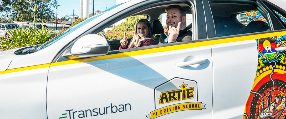 Car being driven, it has ARTIE and Transurban branding.